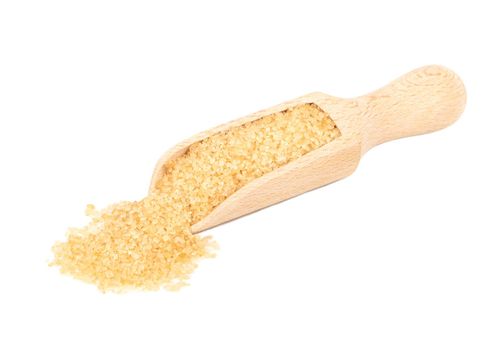 Brown sugar in a wooden scoop on a white background