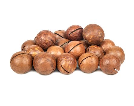 Pile of macadamia nuts in a shell on a white background