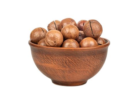 Macadamia nut in a ceramic bowl on a white background