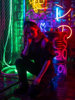 Caucasian woman posing in neon studio