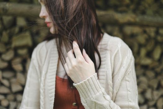 Portrait of a beautiful woman with a long hair. Young brunette model with beautiful hair flying in the wind