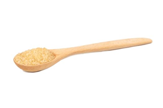 Wooden spoon with brown sugar on a white background