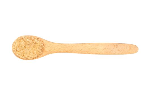 Brown sugar in a wooden spoon isolated on a white background, top view