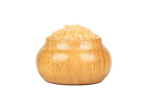 Brown sugar in a wooden container isolated on a white background