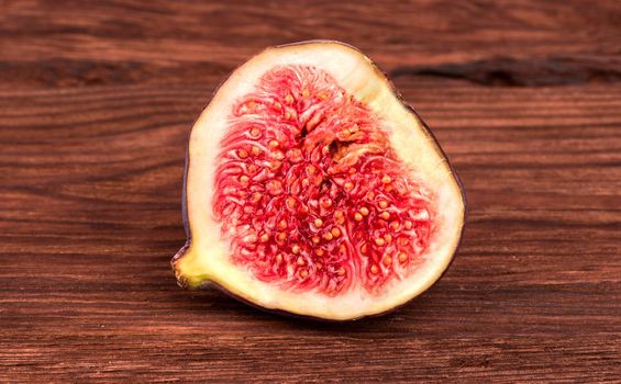 Half sliced fresh figs on a wooden background
