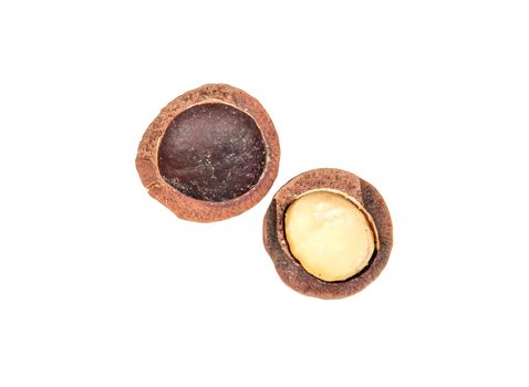 Split macadamia nut isolated on white background, top view