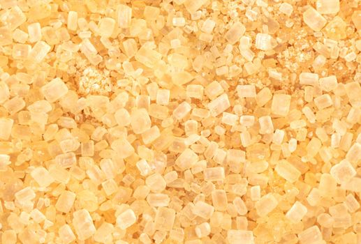 Background of scattered brown sugar close up