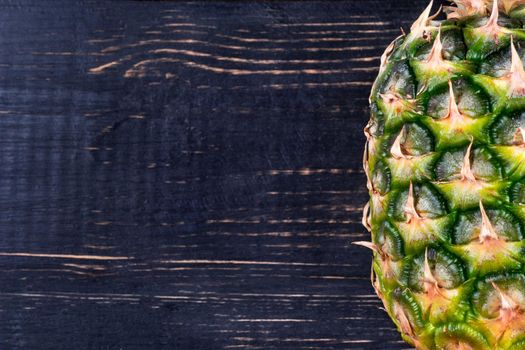 Fresh tropical fruit pineapple on wooden background empty closeup