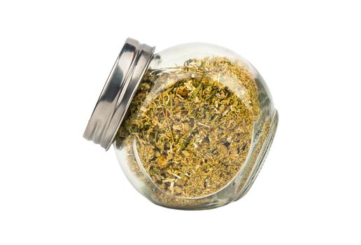 Glass jar filled with dry grass chamomile on a white background