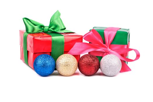 Multicolored Christmas balls with boxes for gifts on a white background