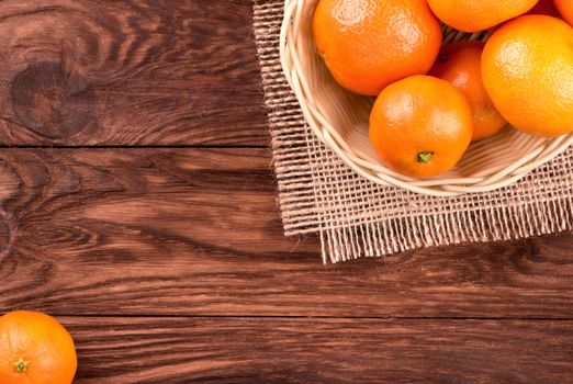 Basket full of ripe mandarins on the table top view