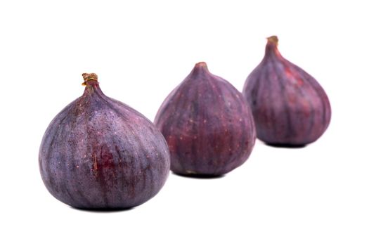 Three fresh and ripe figs isolated on white background