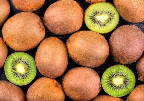 Background of fresh fruit with kiwi halves, top view