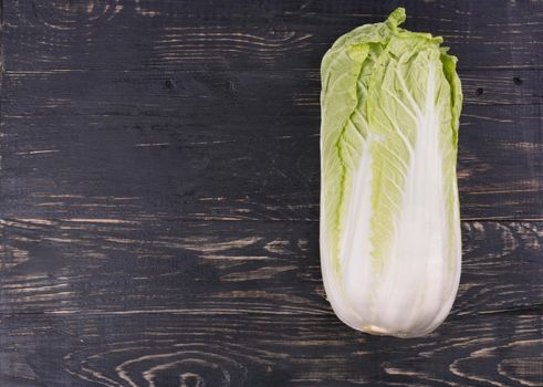 Fresh ripe chinese cabbage on a dark wooden background