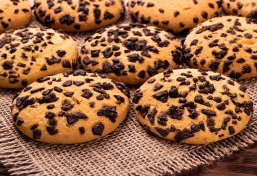 Several cookies with chocolate on sacking close-up