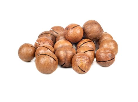 Pile of macadamia nuts in a shell on a white background