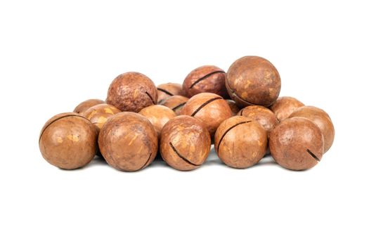 Pile of macadamia nuts in a shell on a white background