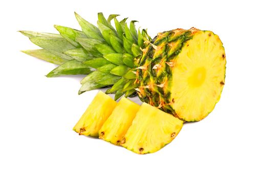 Half fresh pineapple fruit with three slices on a light background