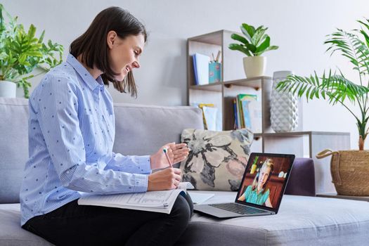 Young female teacher making video conference for child girl sitting in home office. Online meeting of student and teacher, e-learning, remote distance lesson. School, technology, teaching, knowledge