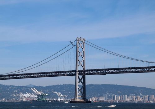 SAN FRANCISCO - OCTOBER 9: four Blue Angels fly behind the San Francisco Bay Bridge with a boat in the water and Oakland visible in the background taken October 9, 2010 San Francisco.