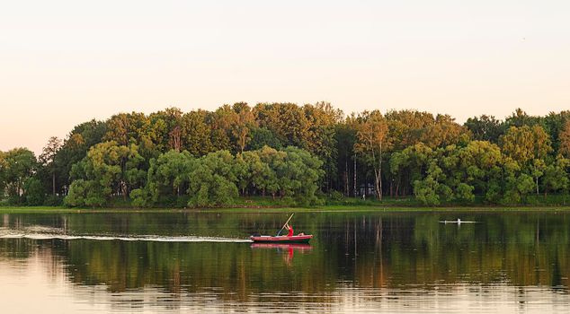 Summer holidays on the river.Sport boating on sunset