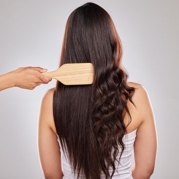 Shot of a woman posing with half straightened and half curled hair.