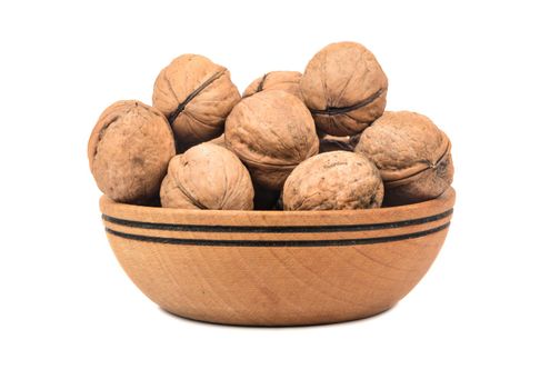 Walnuts in wooden bowl on white background