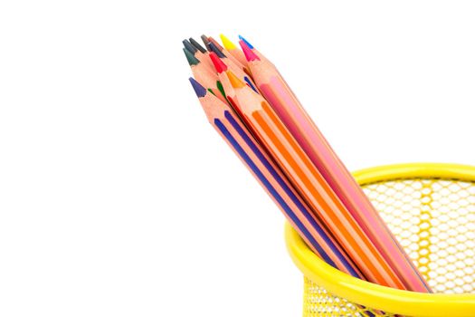 Colored pencils in a metal basket on white background