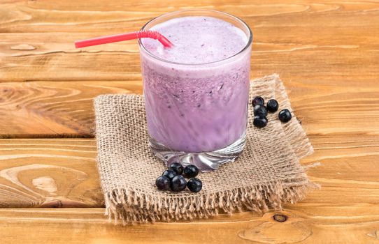 Delicious blueberry smoothie on sackcloth, and the table, close-up