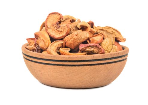 Slices of dry fruit apples in a bowl isolated on white background