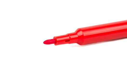 Open red felt-tip pen on a white background closeup