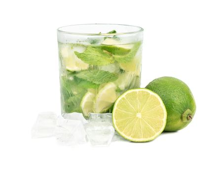 Glass of mojito cocktail with lime and ice on a white background
