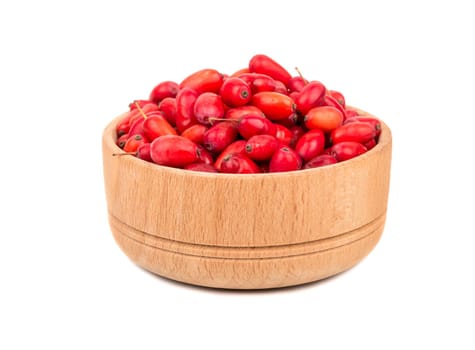 Fresh barberries in a small wooden bowl on white background