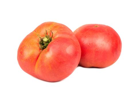 Two ripe large tomatoes on a white background