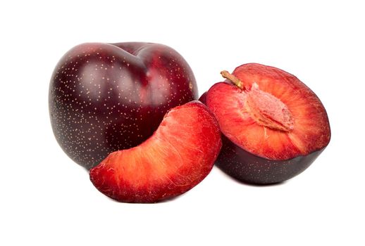 Ripe red plum with half and slice on white background