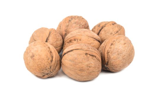 Bunch of walnuts in shell on white background