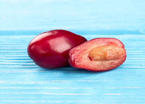 Delicious dogwood with a juicy half on a table close-up