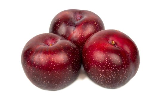 Fresh three red plums on white background