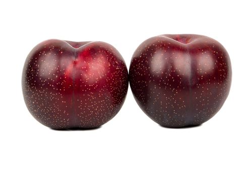 Two ripe big red plums isolated on white background