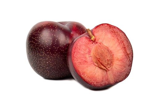 Ripe red plum with juicy half on white background