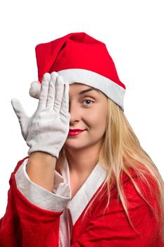 Girl wearing Santa Claus closes his hand one eye on white background