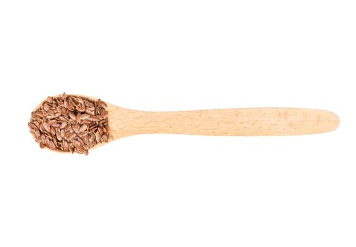 Flax seeds in wooden spoon isolated on white background, top view