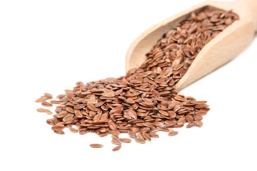 Flax seed in wooden scoop on white background