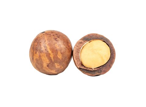 Macadamia nut with split half isolated on white background