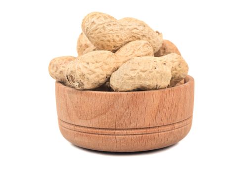 Peanuts in the shell and a wooden bowl isolated on white background