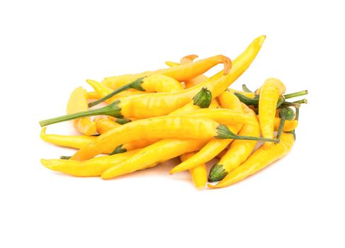 Heap of yellow hot peppers on a white background