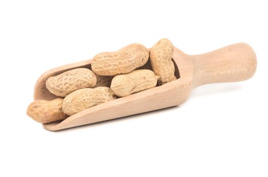 Peanuts in the shell and wooden scoop on white background