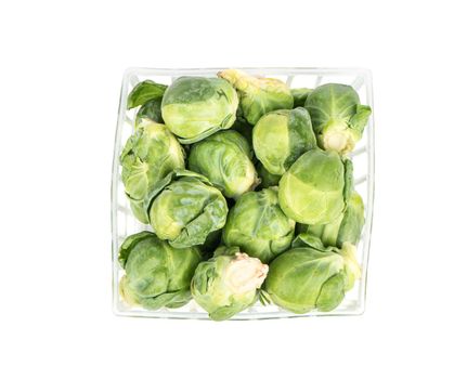 Fresh brussels sprouts in a box on a white background, top view