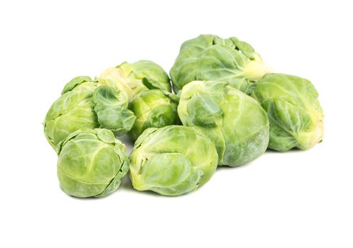 Small bunch of fresh Brussels sprouts on a white background