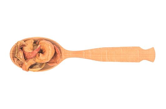 Wooden spoon with dry fruit slices of apple on white background, top view
